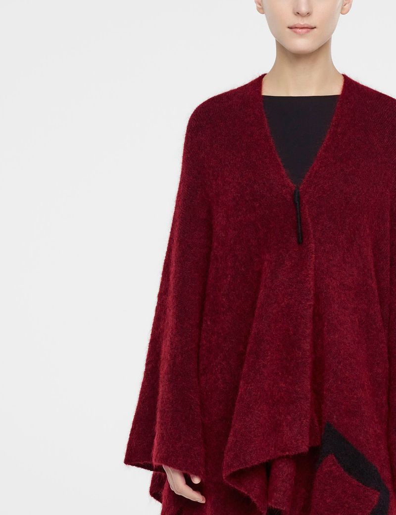 Red mohair poncho by Sarah Pacini