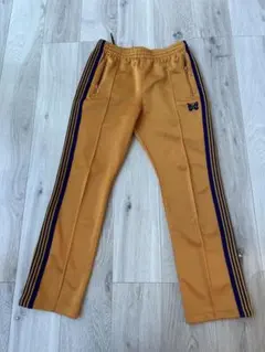 2026年最新】needles トラックパンツ マスタードの人気アイテム - メルカリ